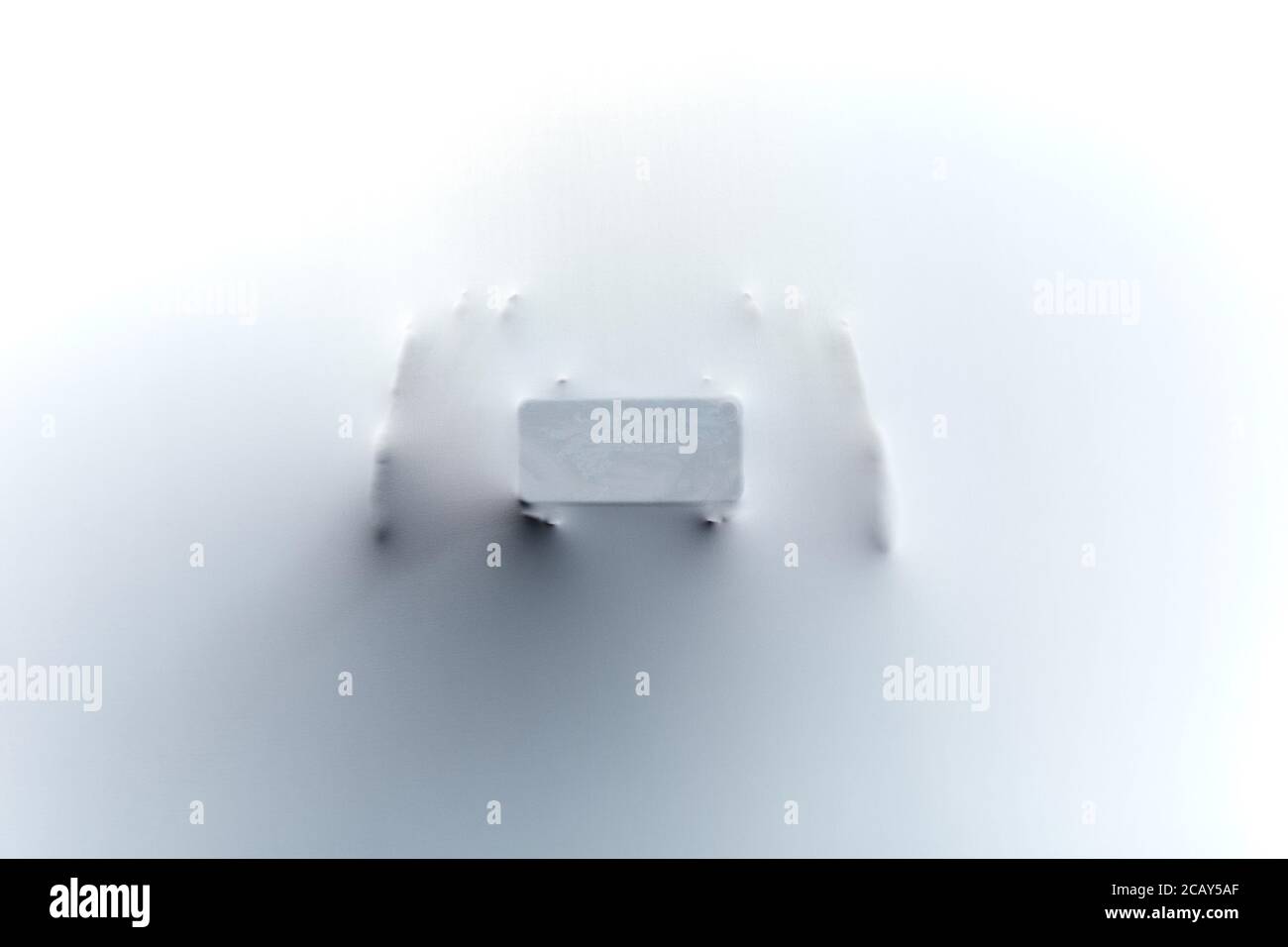 woman holding a phone and taking a photo while standing behind the cloth, textile. close up