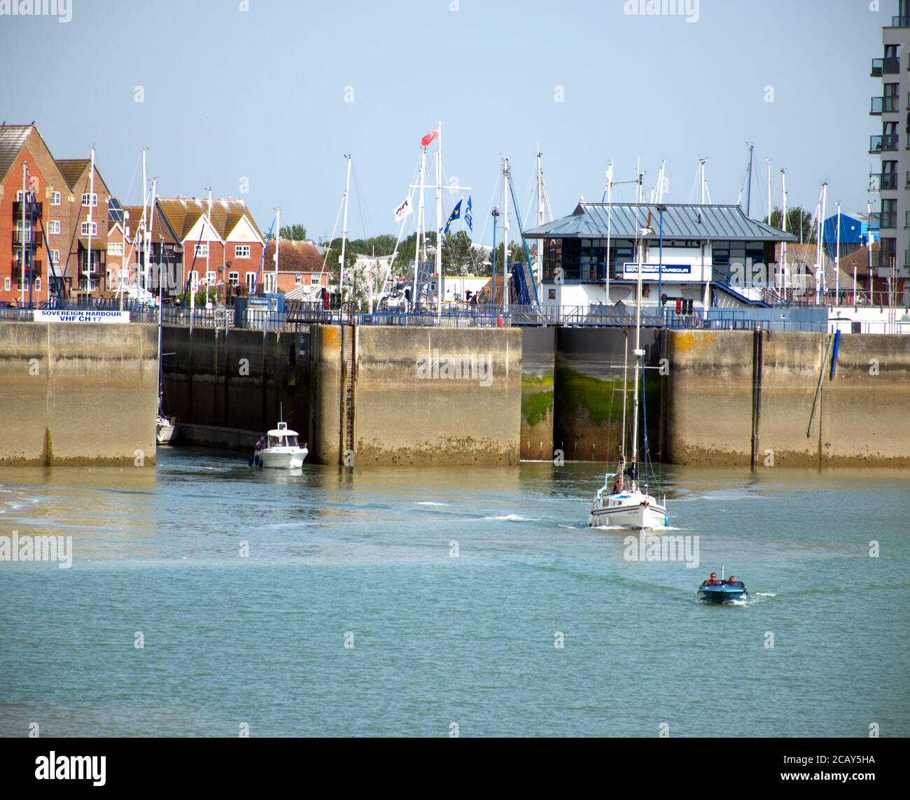The locks opening to let out small boats from Soverign Harbour, Eastbourne, Sussex, England, UK. Stock Photo