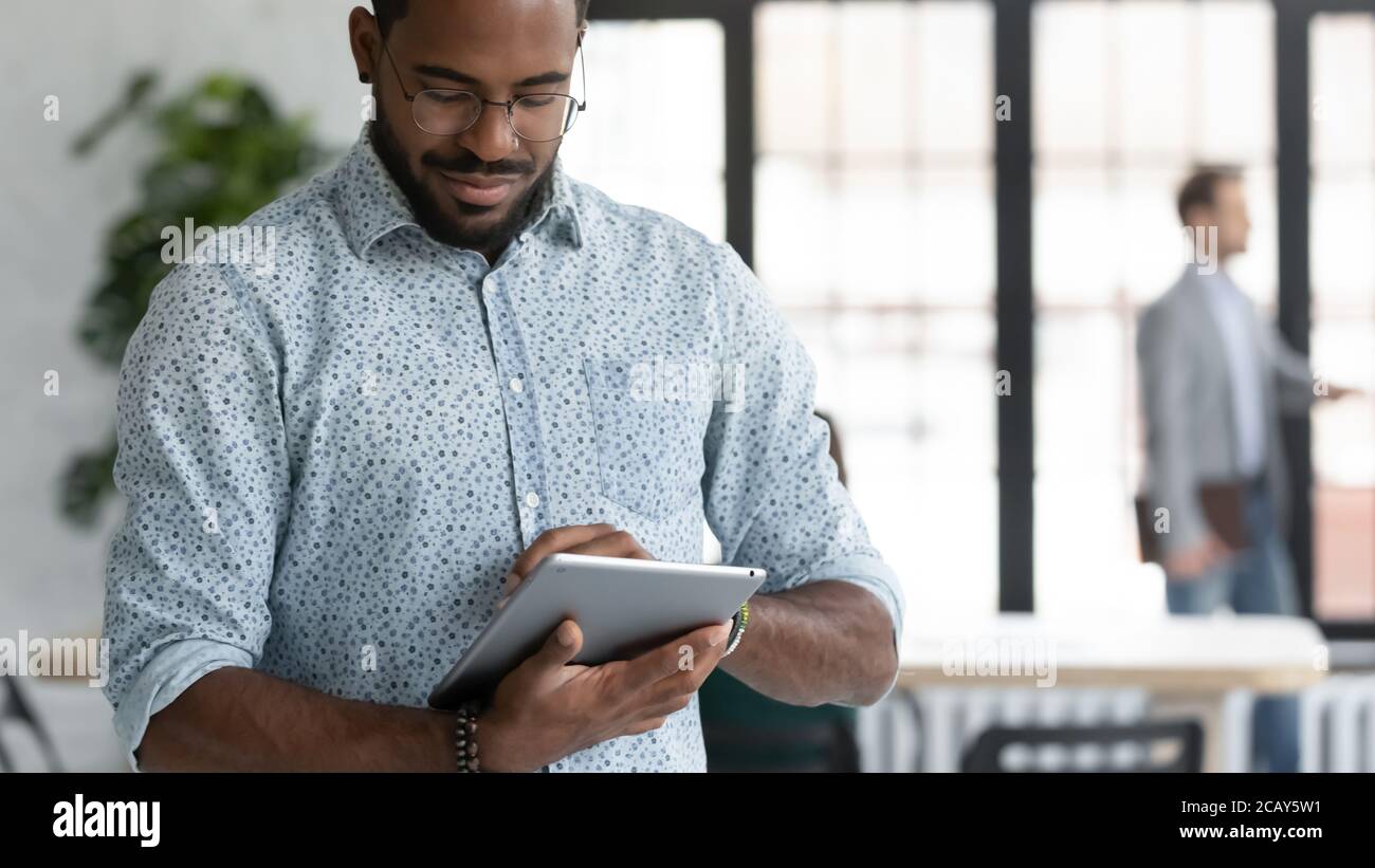 Close up focused African American businessman using computer tablet Stock Photo
