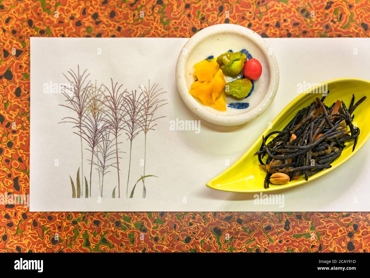 Japanese traditional fermented tsukemono condiments like takuan daikon radish, cucumber or karikari-koume plum with hijiki brown sea vegetables on a p Stock Photo