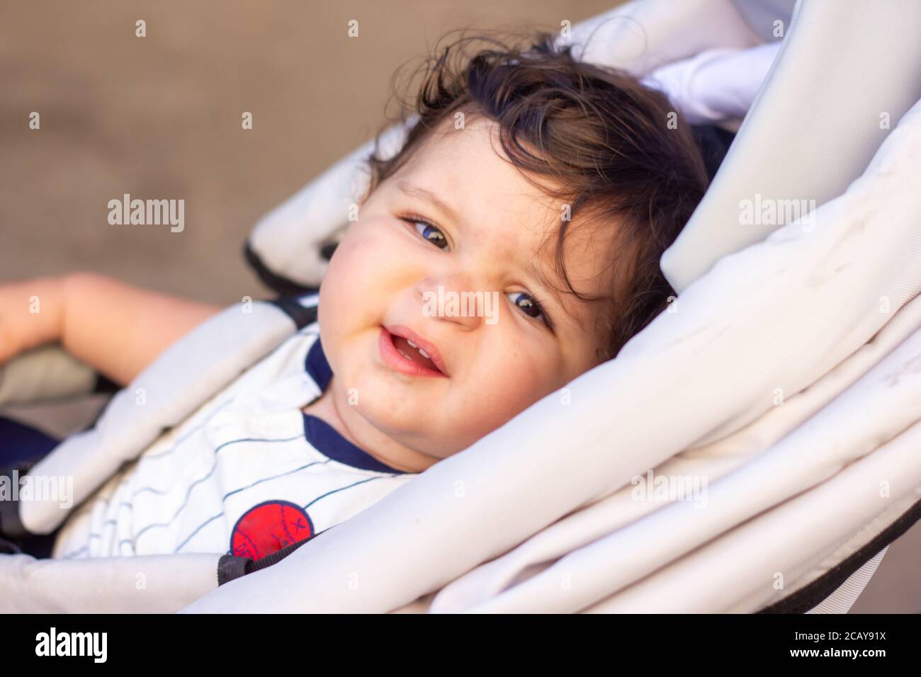 a little baby boy in a wheelchair Stock Photo Alamy