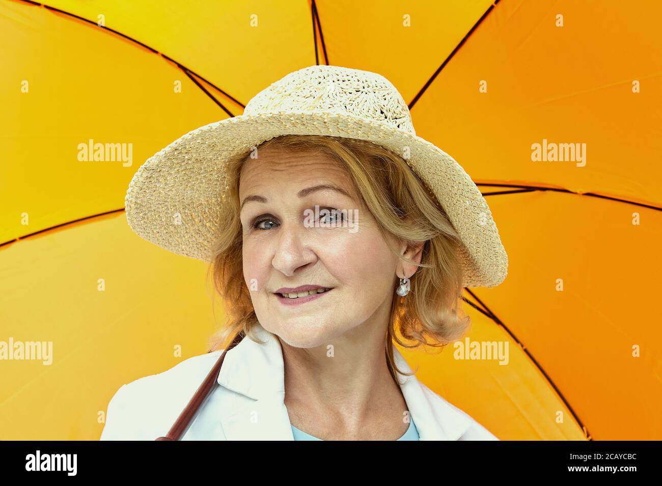 Portrait of white aged woman about 60 years old. Elderly lady is