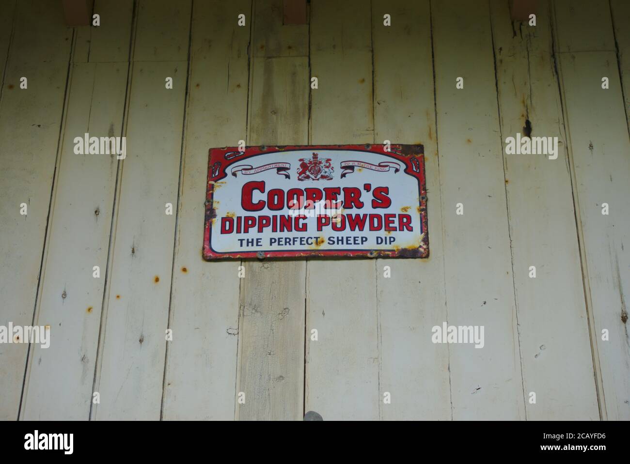 Vintage metal advertising plate for Cooper's Dipping Powder, 'the perfect sheep dip', Melrose railway station, Roxburghshire, Scottish Borders, UK. Stock Photo
