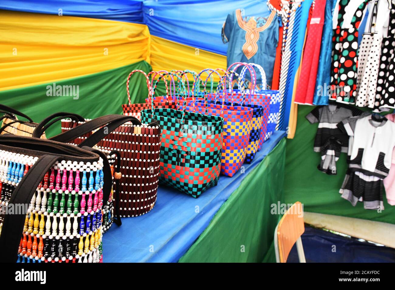 Made in Rwanda bags and women clothes in an exhibition with Rwandan flag in the background Stock Photo