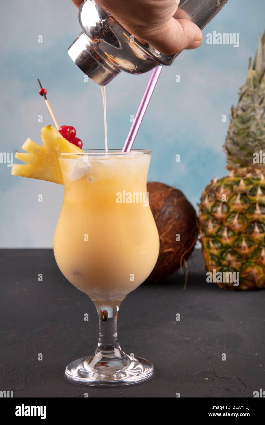 Pina Colada over wooden background garnished pineapple. A cocktail "Coconut  Kiss Stock Photo - Alamy
