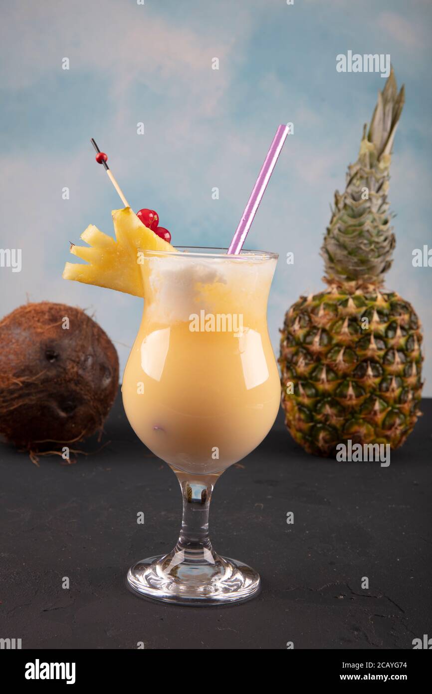 Pina Colada over wooden background garnished pineapple. A cocktail "Coconut  Kiss Stock Photo - Alamy