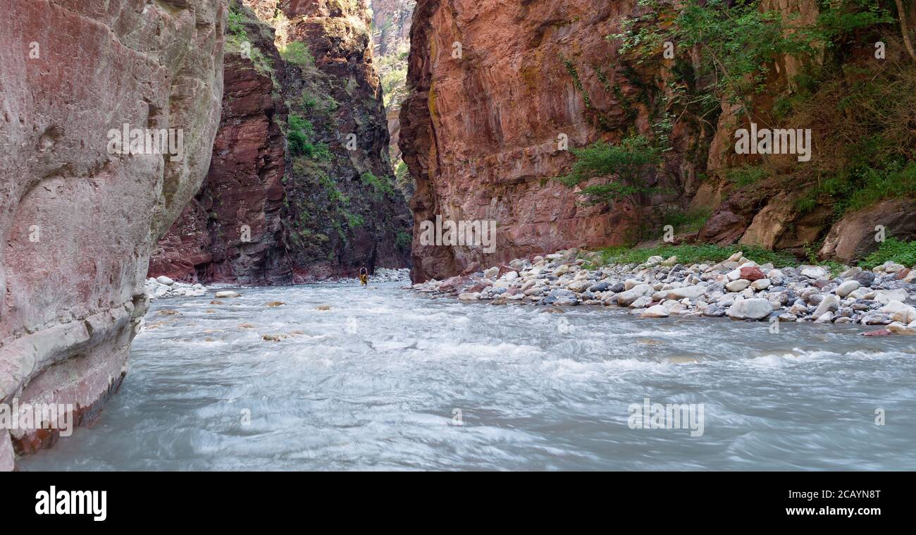 Walking in water through red cliffs in Daluis Gorge or Daluis Canyon. Var River, Guillaume, Alpes-Maritimes, France Stock Photo