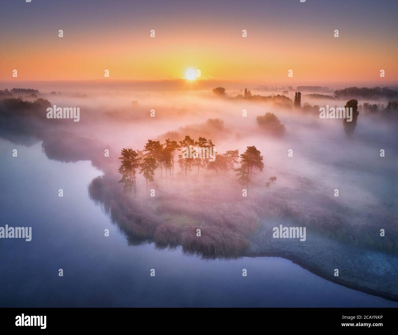 Aerial view of foggy forest at colorful sunrise in autumn Stock Photo