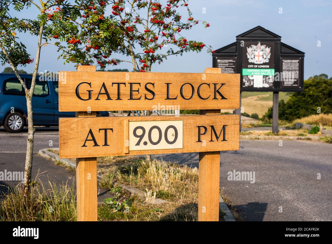 Gates lock at 9 PM sign at the car park in Farthing downs Stock Photo