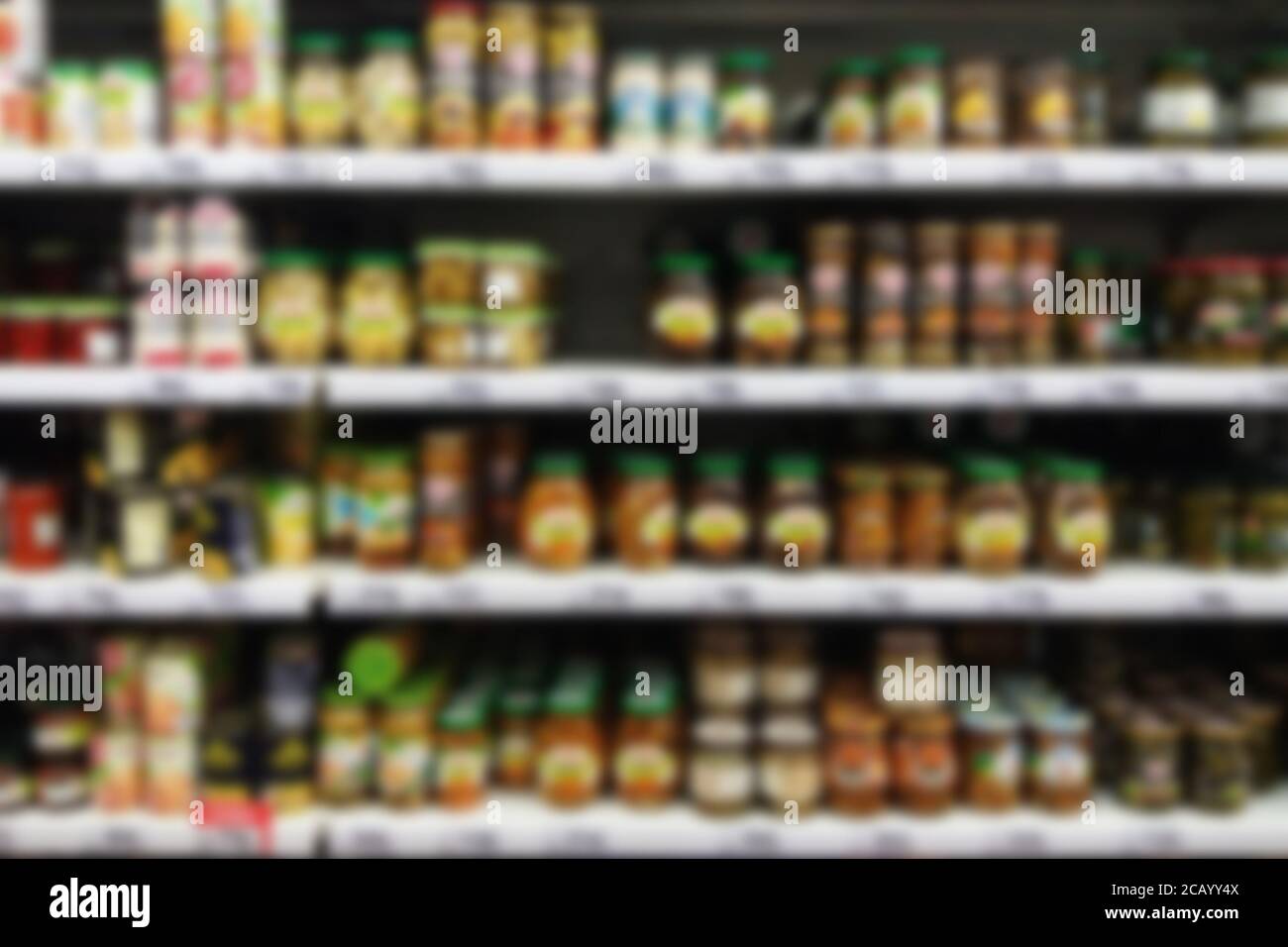 blurry supermarket selves with pickled vegetables and mushrooms in jars Stock Photo