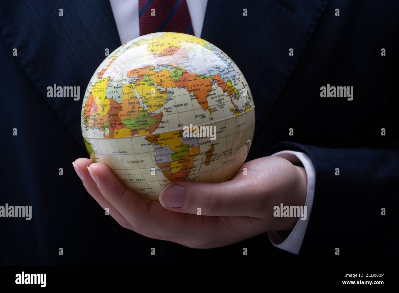 Businessman is standing with an earth globe fot business concept Stock ...