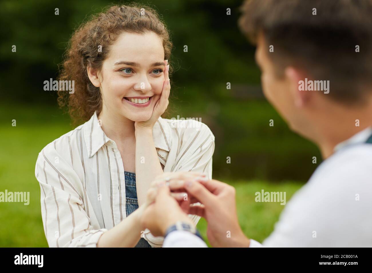 Close up portrait of beautiful young woman looking at boyfriend while