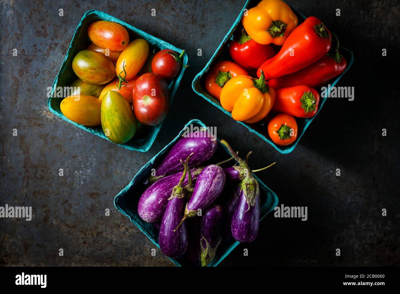 Boxes of tomatoes, peppers and fairy tale eggplants Stock Photo