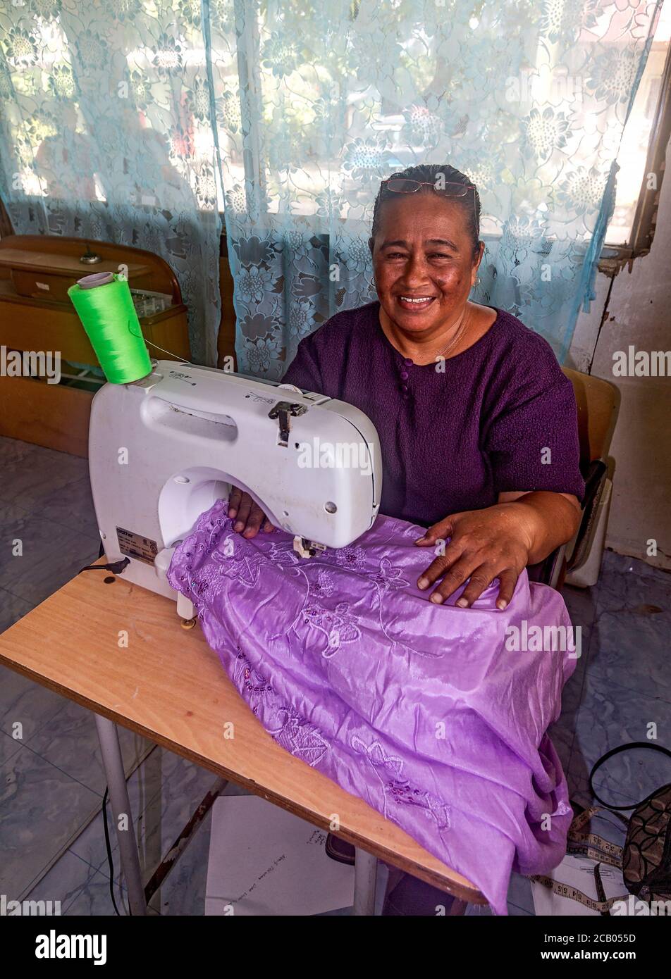 Seamstress working on hand made skirt for visitor to Kosrae, Micronesia. Stock Photo