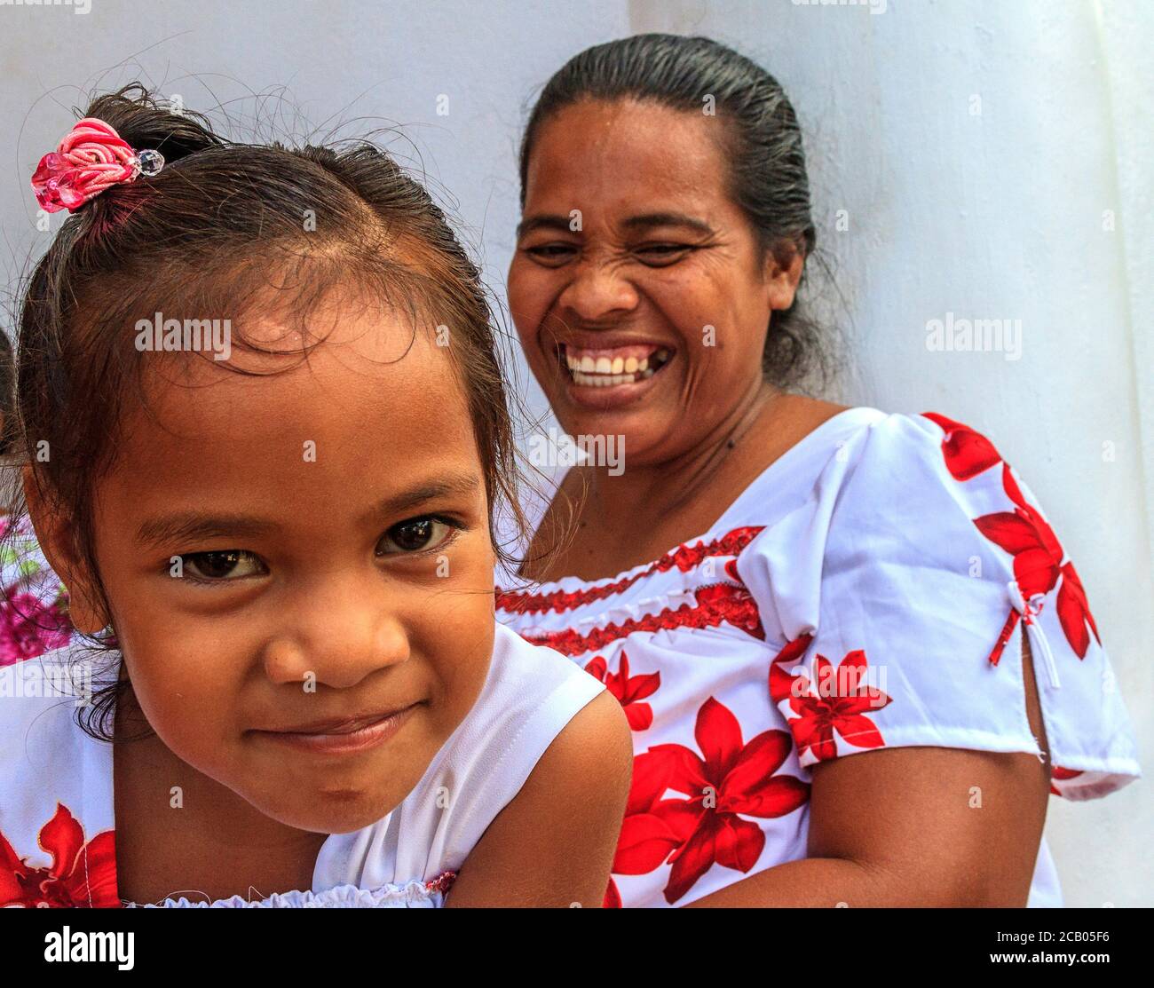 Mother and young daughter dressed in matching outfits for church in Tafunsak on Kosrae, Micronesia. Stock Photo