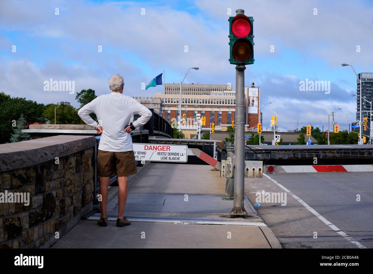 Pedestrian waiting at Lowered gate at entrance of Pretoria Bridge as