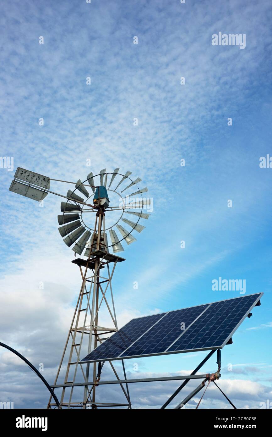 Farm windmill and solar panels with a water tank powered by solar power