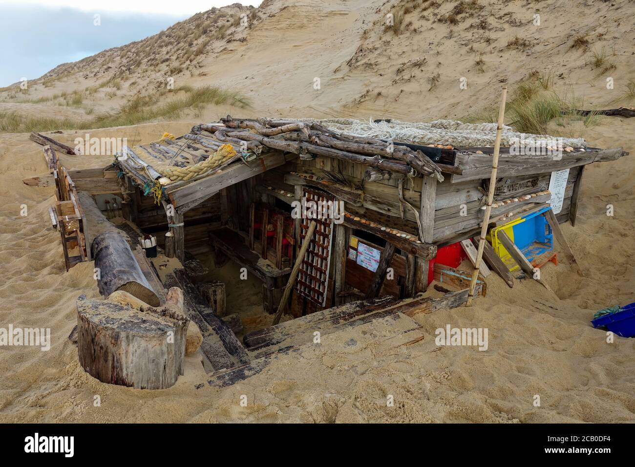 wooden hut made out of trash in the dunes of a wild Atlantic beach at Lacanau Ocean, Gironde, France 2020 Stock Photo