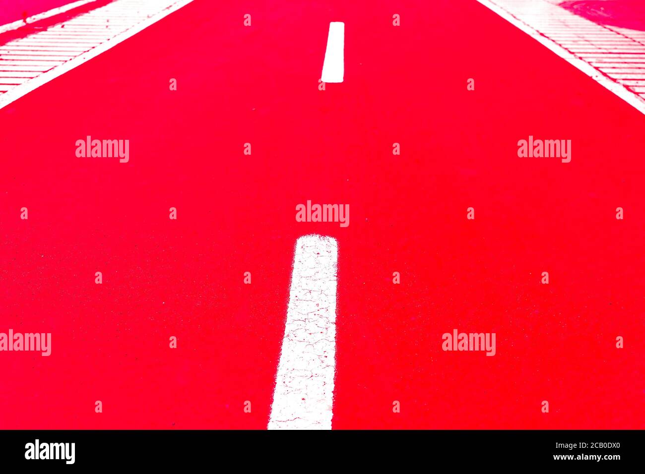 White dashed line limiting bike lanes, painted with luminescent paint, bike road markings, flash