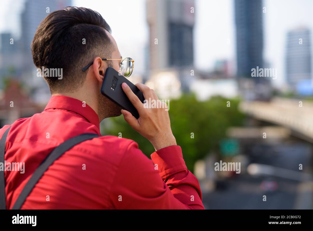 Young handsome Persian businessman exploring the city Stock Photo