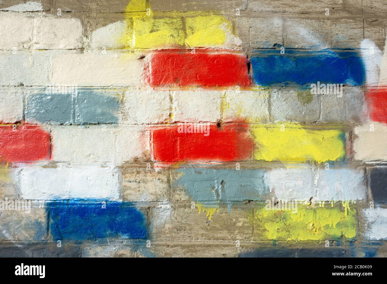 Coloured bricks on a wall background with vintage bricks, mortar and abstract colour patterns. Stock Photo