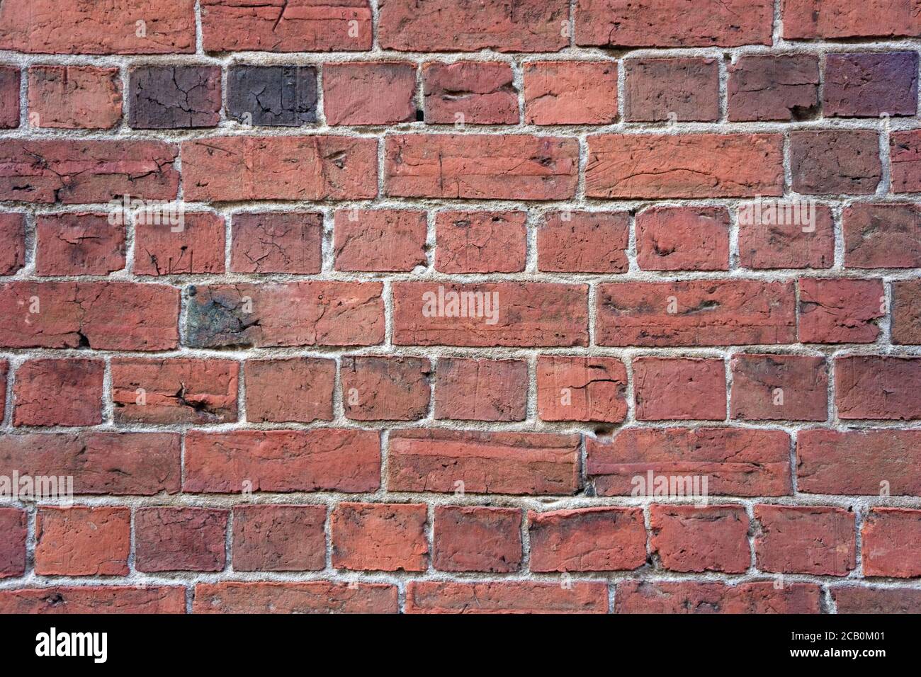 Old brick wall background with vintage brick shapes, mortar and abstract line patterns. Stock Photo