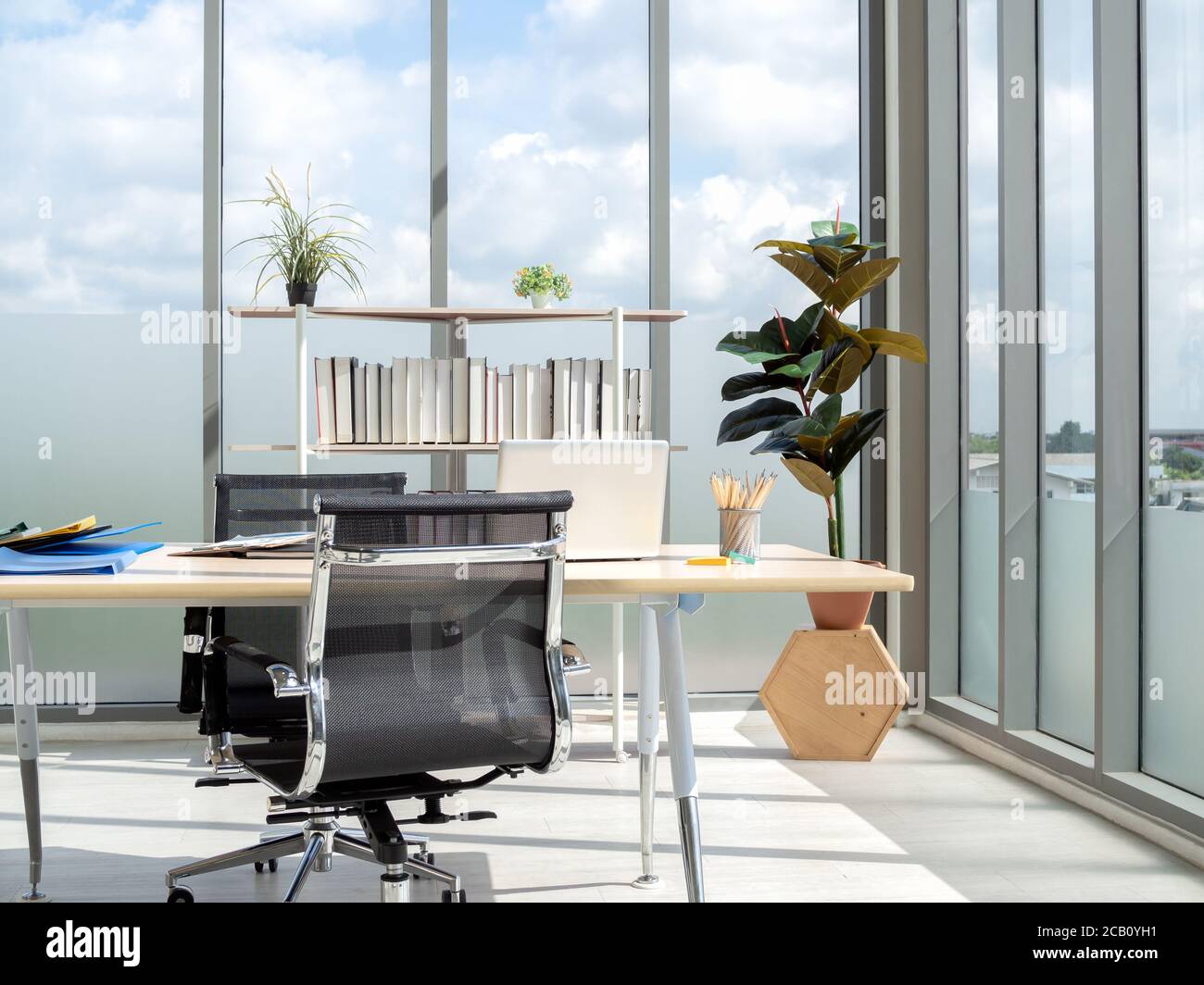 Modern office interior with huge windows with blue sky view. Wooden