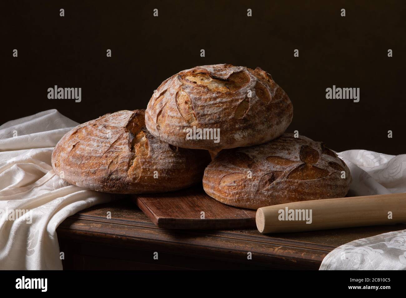 Freshly baked sourdough bread with floral decoration on it Stock Photo