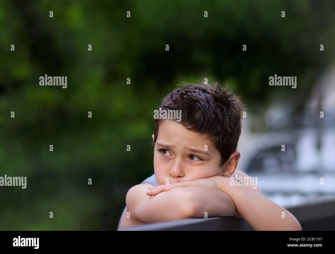 Young Boy Deep in Thoughts Stock Photo - Alamy
