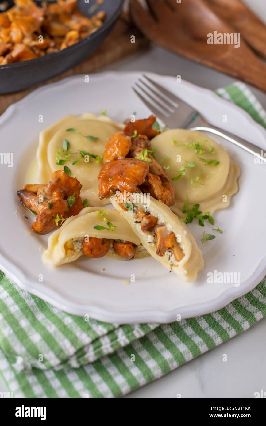 home made Italian ravioli with fresh roasted chanterelles Stock Photo
