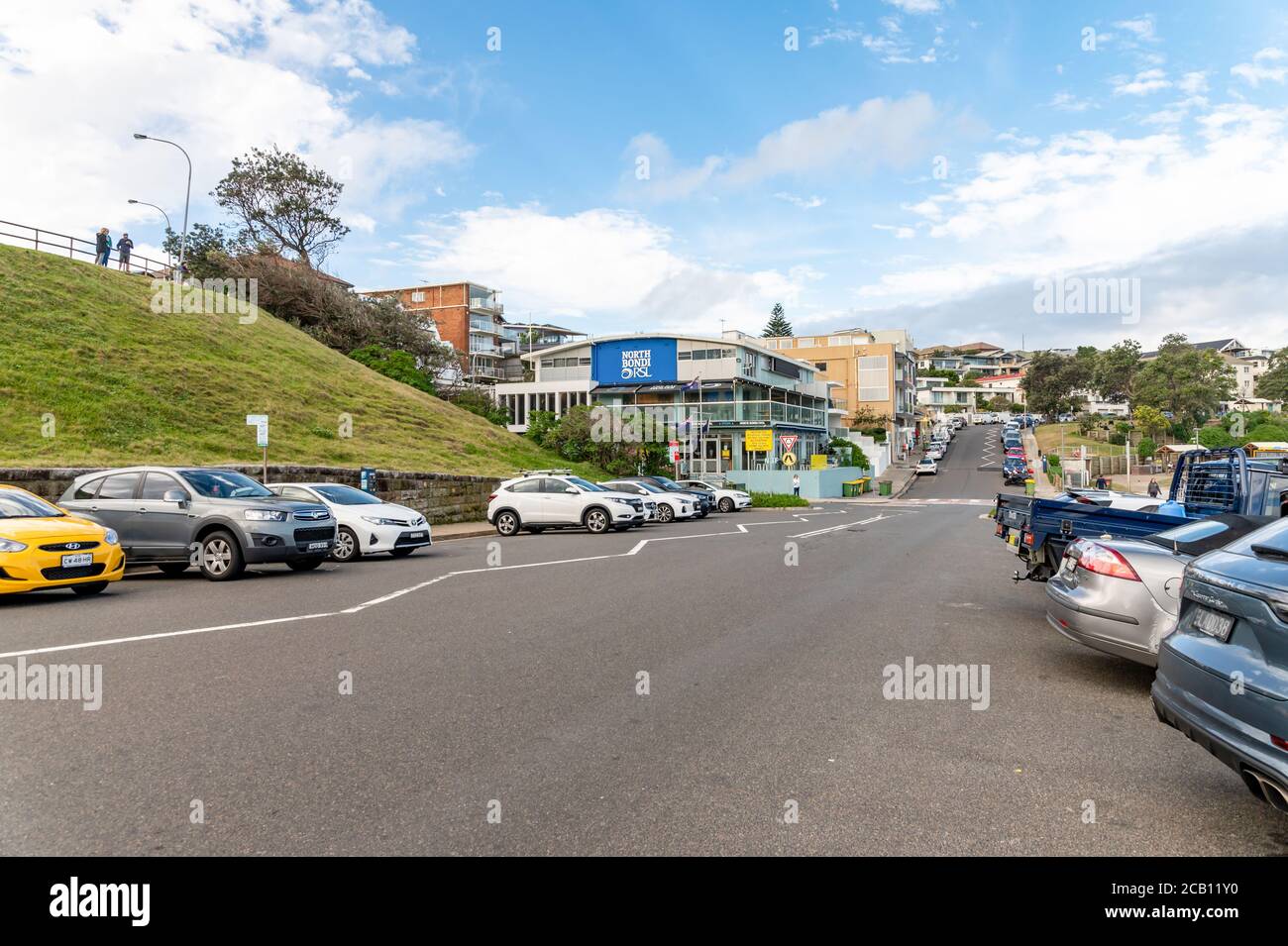 Off street car park and North Bondi RSL Club Background on a sunny autumn afternoon with blue sky and clouds Stock Photo