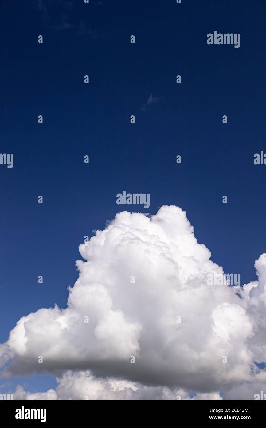 Large cumulus cloud in a deep blue sky Stock Photo