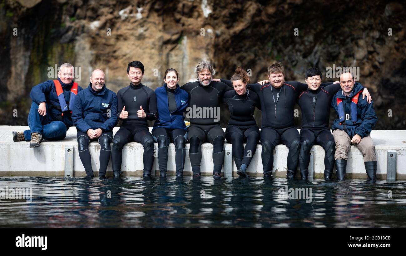 (left to right) James Burleigh, Andy Bool, Jay Shi, Audrey Padgett, John Bishop, Jessica Whiton, Harry Tolliday, Iker Wang and Rob Hicks, the Sea Life Trust team responsible for the transfer of Beluga Whales Little Grey and Little White from the landside care pool to the bayside care pool where they will be acclimatised to the natural environment of their new home at the open water sanctuary in Klettsvik Bay in Iceland. The two Beluga whales, named Little Grey and Little White, are being moved to the world's first open-water whale sanctuary after travelling from an aquarium in China 6,000 mile Stock Photo