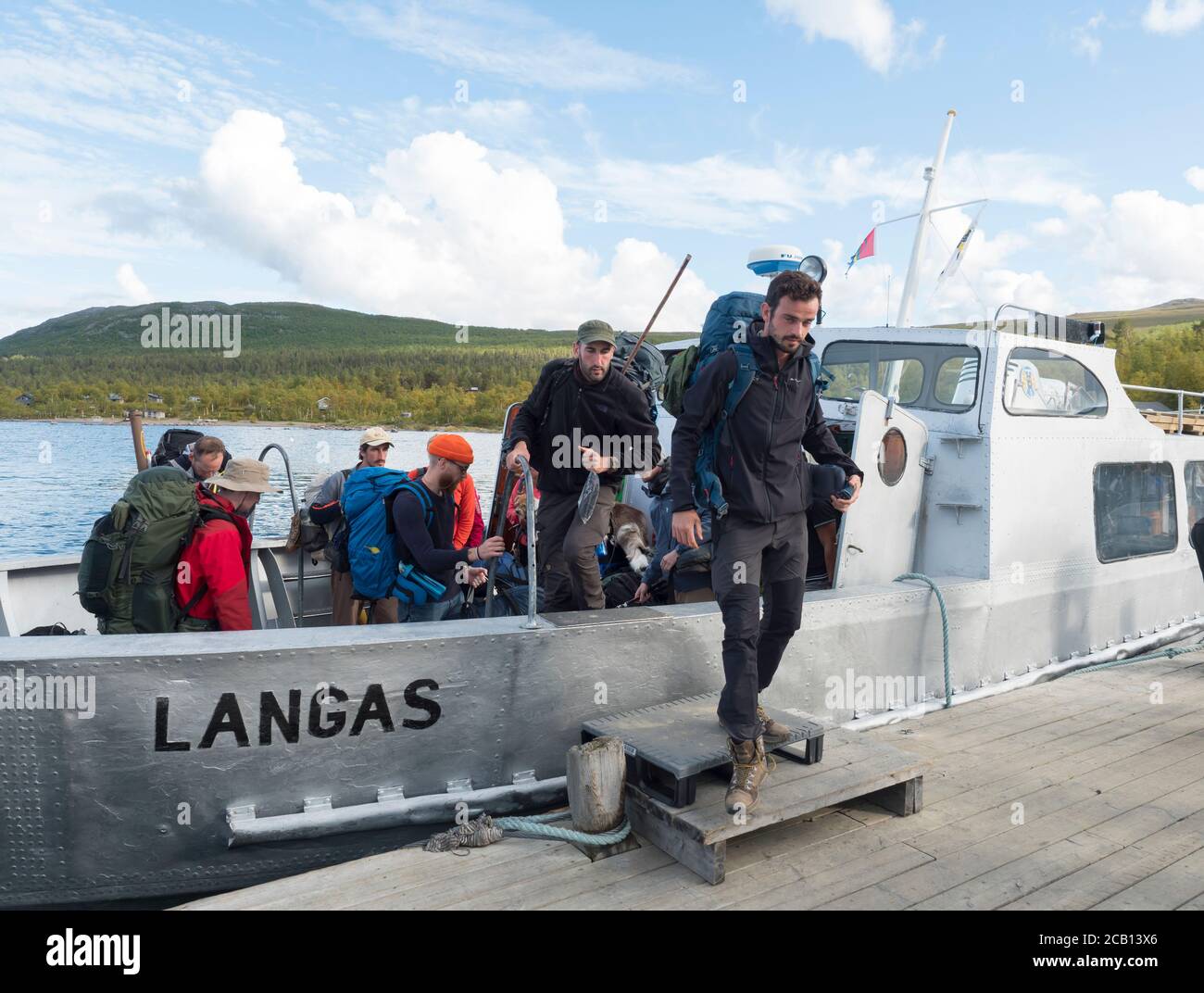 Vakkotavare, Norrbotten, Sweden, Agust 30, 2019: group of hikers and tourist getting off ferry boat ship transport from Vakkotavare to Saltoluokta Stock Photo