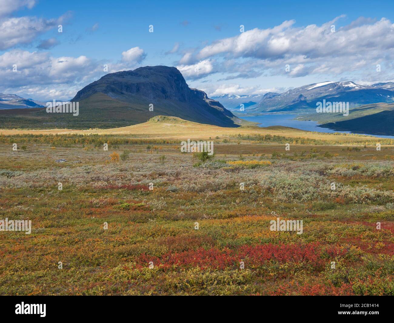 Lapland landscape with Lulealven river, snow capped mountain at Kungsleden hiking trail near Saltoluokta, Sweden. Wild nature with autumn colored Stock Photo