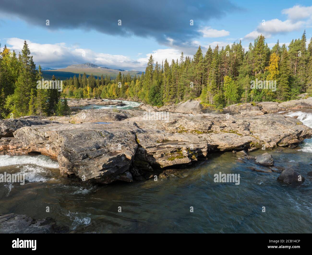 Beautiful northern landscape with wild glacial river Kamajokk, boulders ...