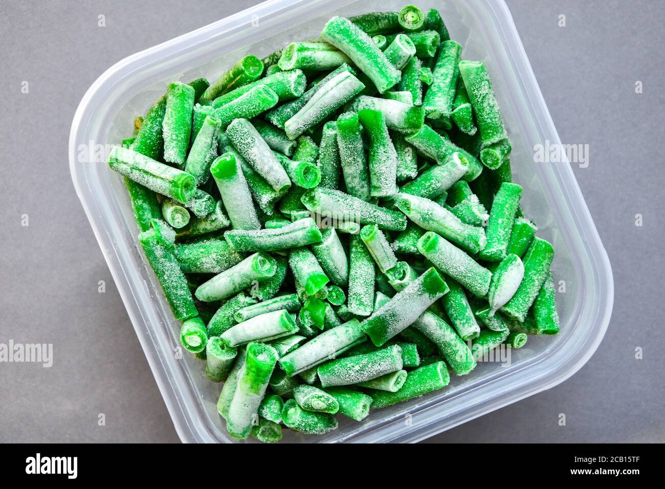Frozen green beans in a plastic container for longterm storage. Deep