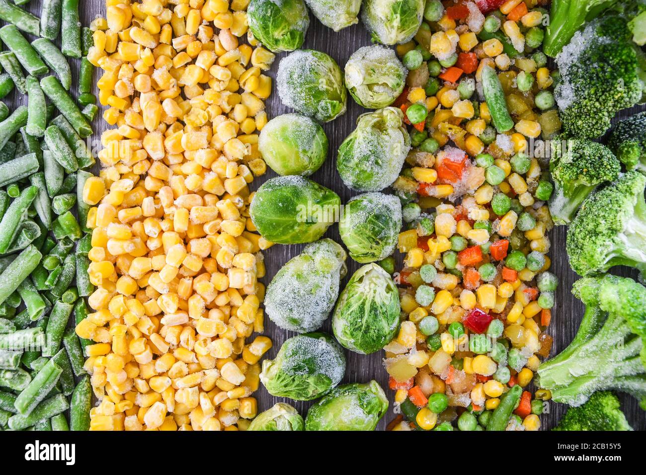 Different frozen vegetables as background, top view. Stocking up vegetables for winter storage