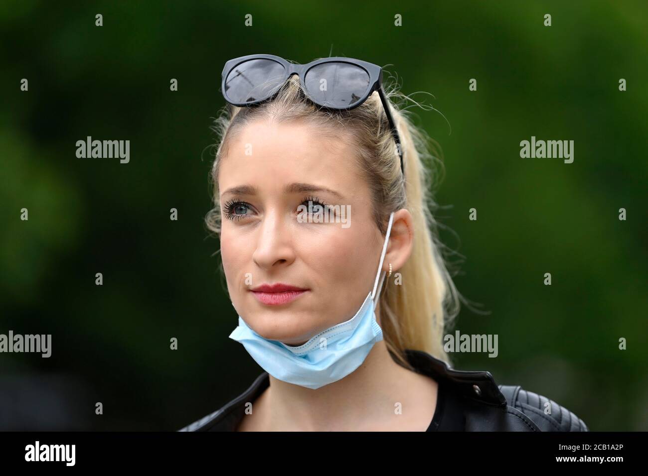 Woman wearing a face mask under the chin, portrait, Corona crisis, Germany Stock Photo