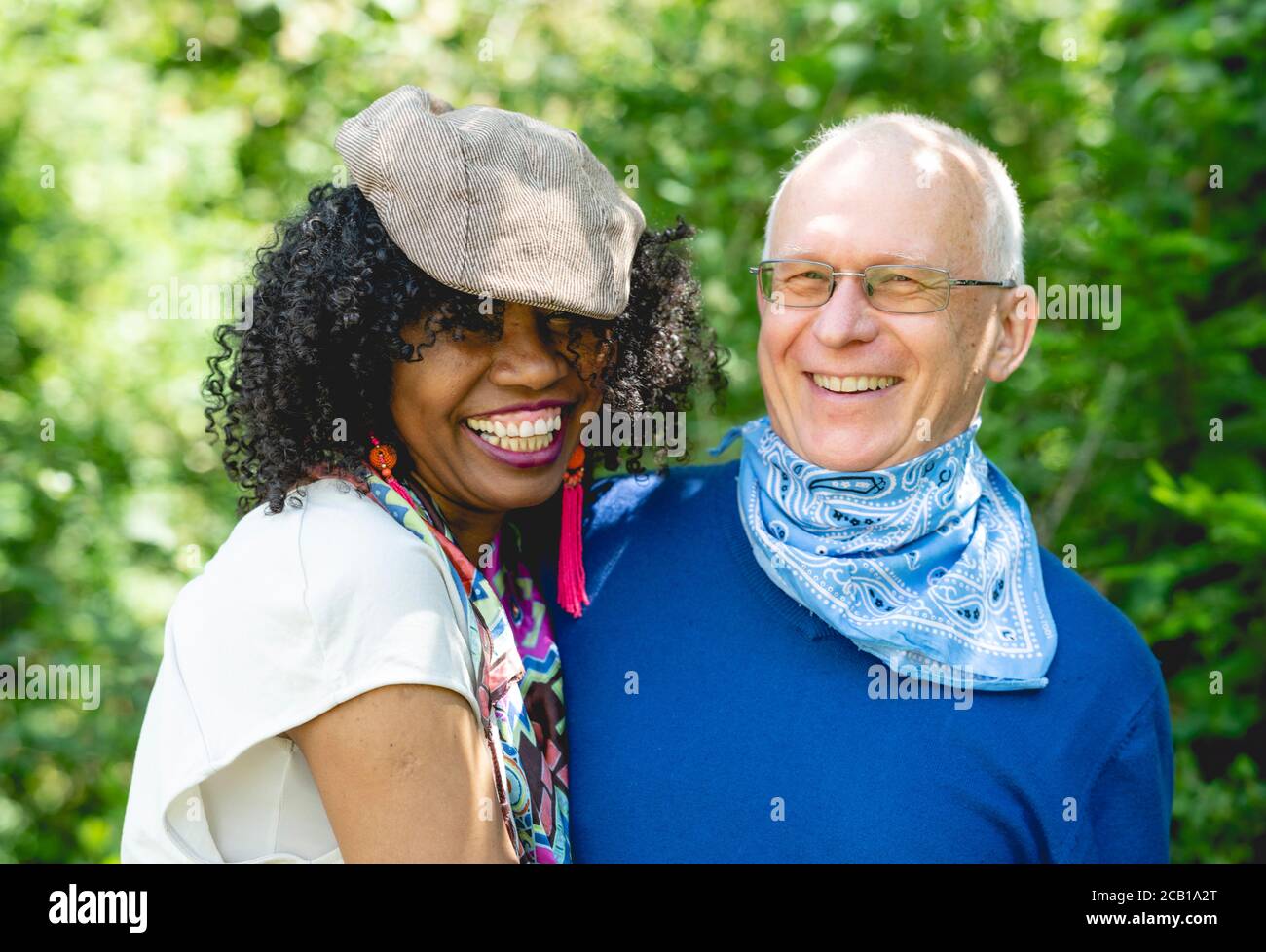 Portrait of a laughing married couple, dark-skinned woman and light-skinned man, mature couple, Germany Stock Photo