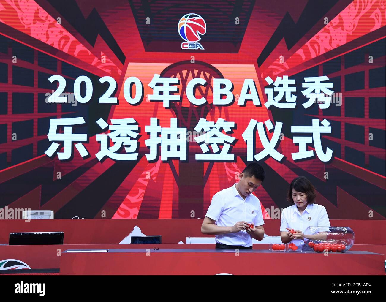 Qingdao. 10th Aug, 2020. Notaries examine the slips prior to the 2020 CBA draft lottery ceremony in Qingdao of east China's Shandong Province on Aug. 10, 2020. Shanghai Sharks won the first pick, Guangzhou Loong Lions and Tianjin Pioneers got the second and third pick respectively. Credit: Zhu Zheng/Xinhua/Alamy Live News Stock Photo