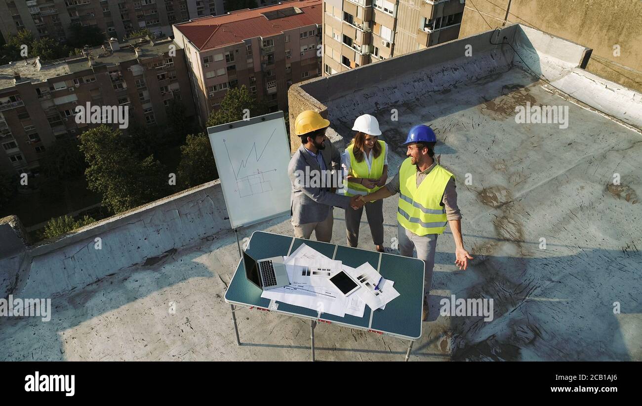 Team of architects people in group on construciton site check documents and business workflow. Stock Photo