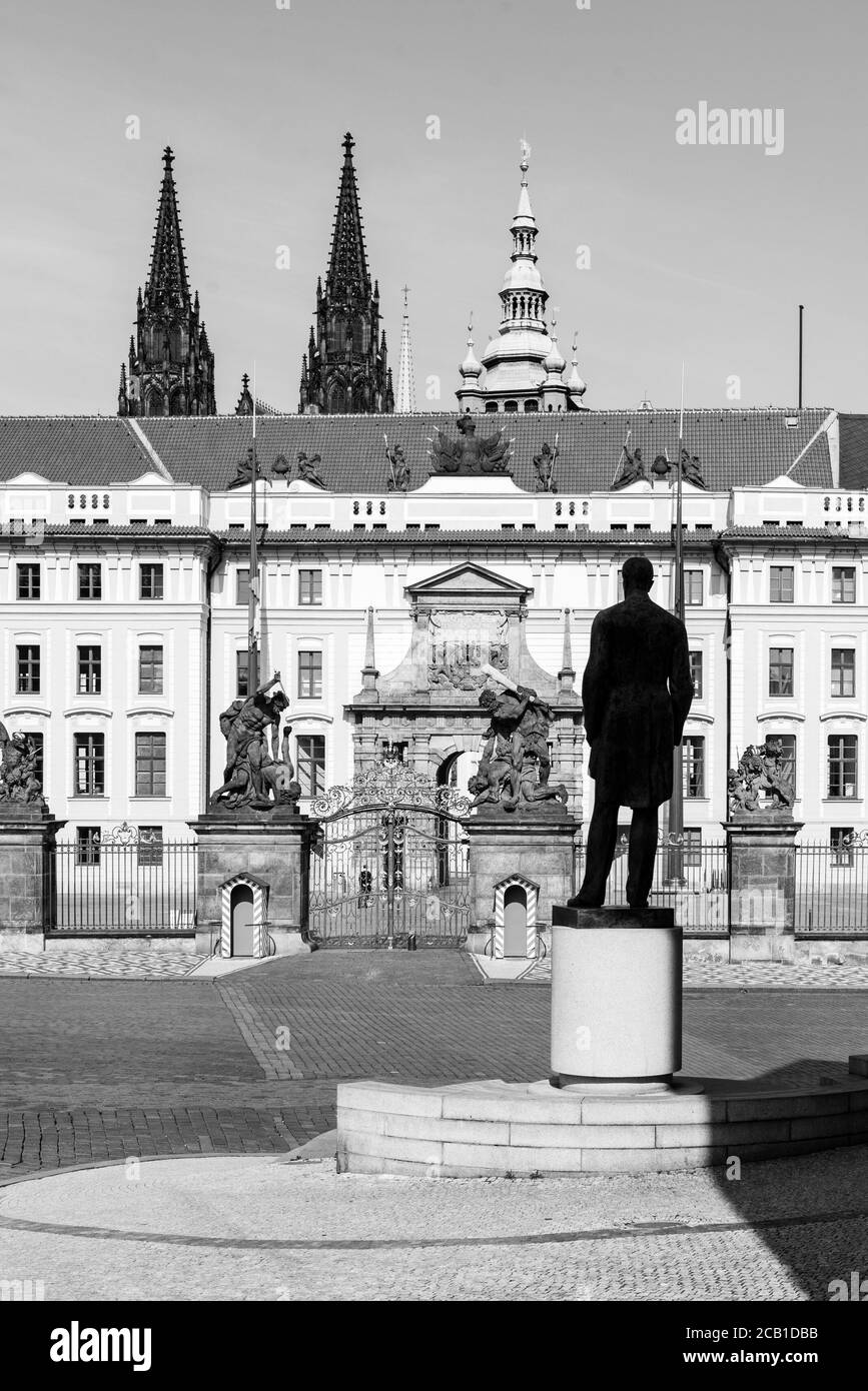 Hradcany square with entrance gate to Prague Castle and statue of Tomas Garrigue Masaryk - the first President of Czechoslovakia, Praha, Czech Republic. Black and white image. Stock Photo