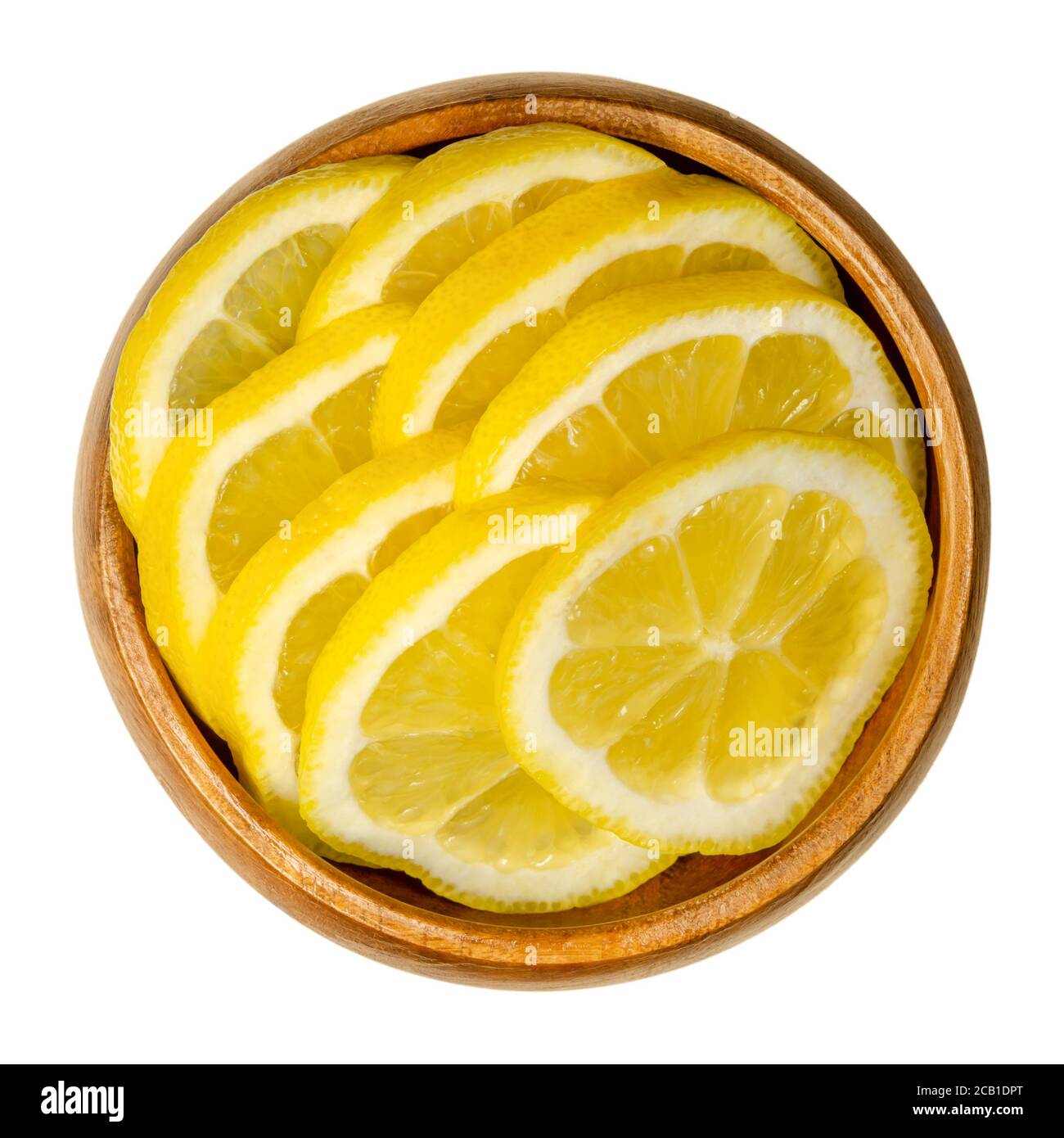 Fresh lemon slices in a wooden bowl. Sliced ripe yellow citrus fruits. Citrus limon. Lemons are used for culinary purposes and for cleaning. Stock Photo