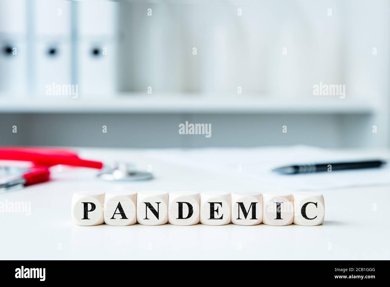 the word pandemic on wooden blocks in a doctor's office Stock Photo