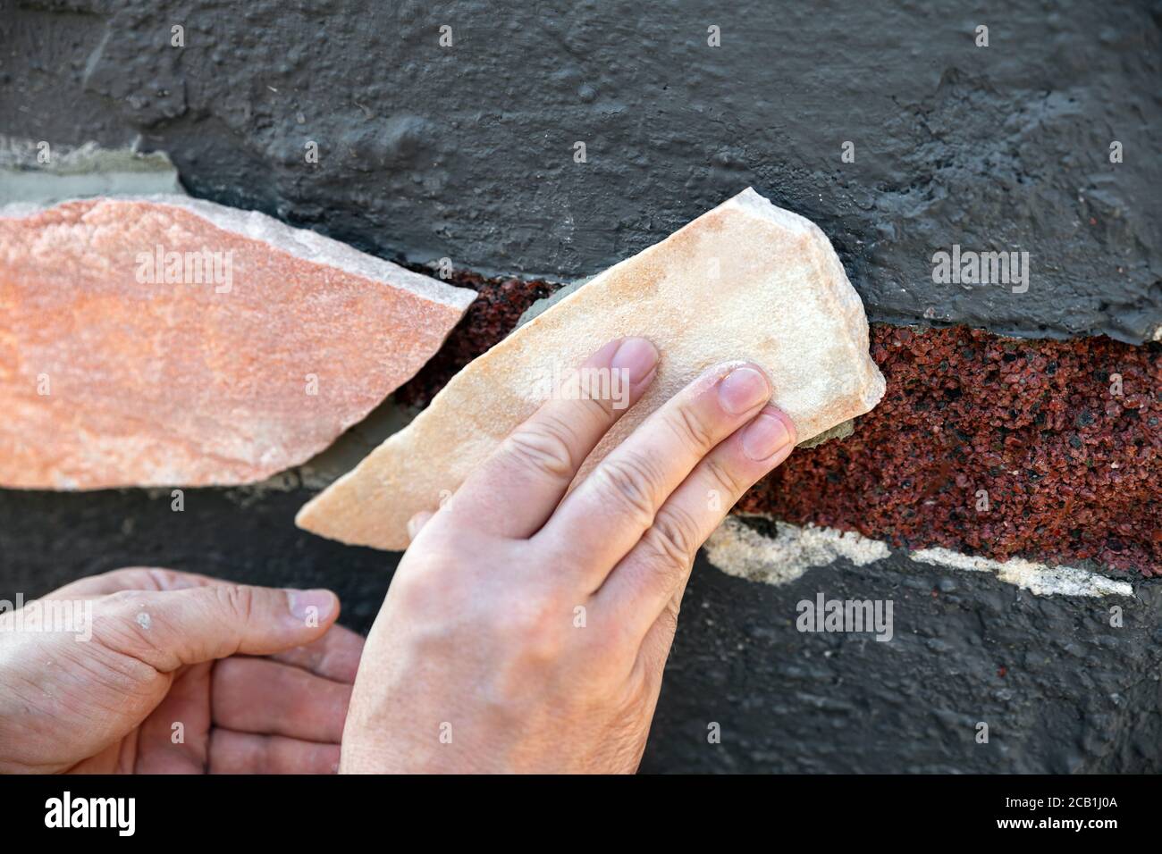 freshly laid quartzite stone slabs, tile adhesive and grey grout
