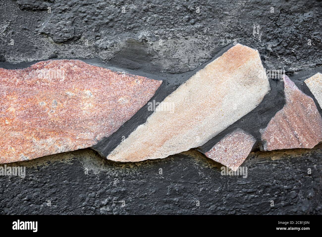 freshly laid quartzite stone slabs, tile adhesive and grey grout, outdoor Stock Photo