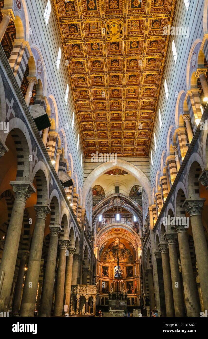 The interior of the Pisa Cathedral, with marble columns having Corinthian capitals and the beautiful coffer ceiling of the nave. The gold-decorated... Stock Photo