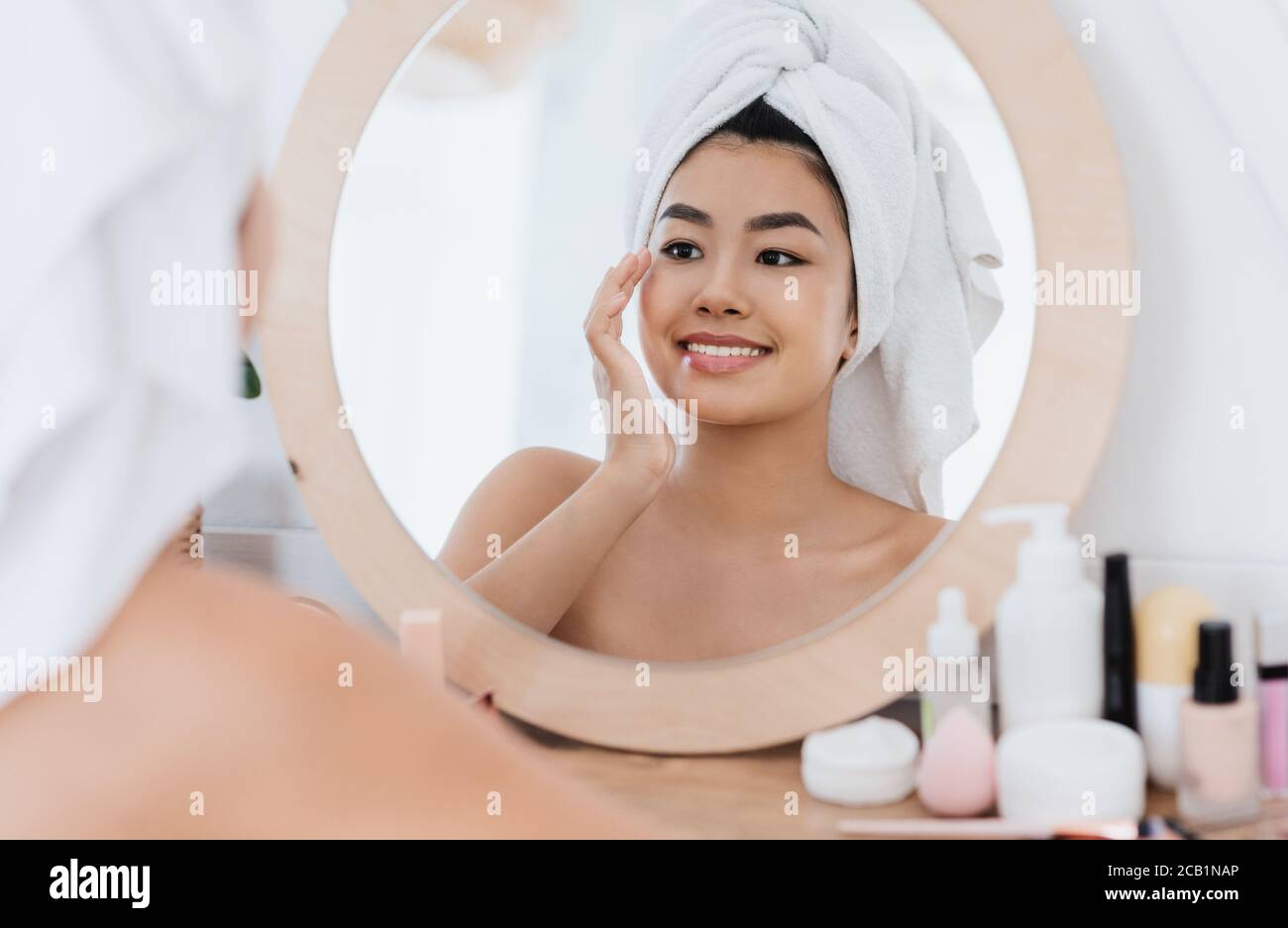 Asian woman rubbing her eye zone after shower at home Stock Photo