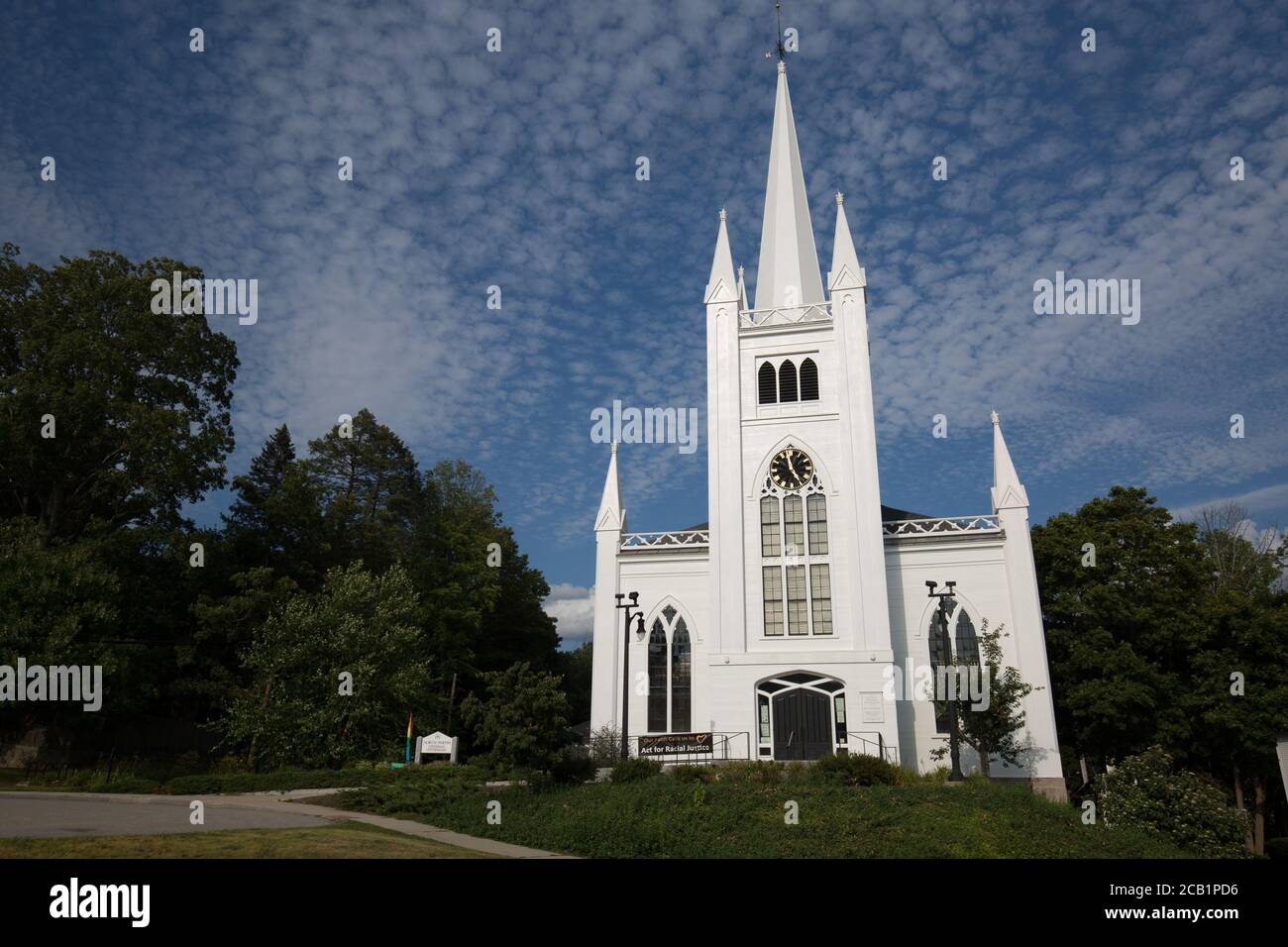 Beautiful church at north andover with bright blue sky and light cumulus cirrus scattered clouds Stock Photo